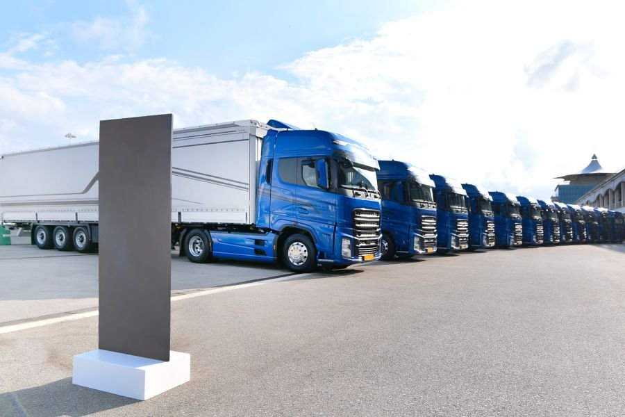 Curtain-side trailers coupled to blue tractor units