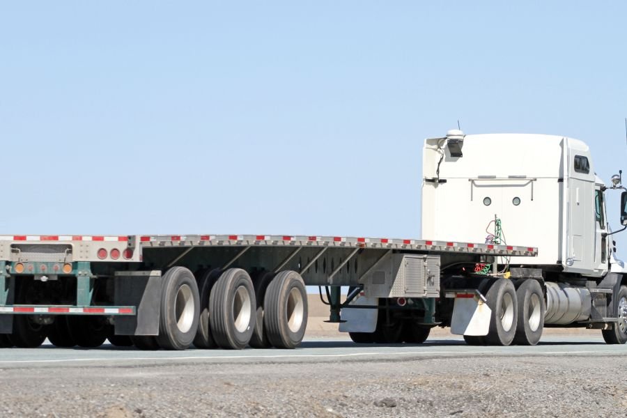 Flatbed trailer coupled to a tractor unit ready for loading