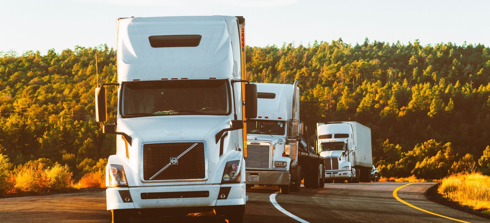 Sama Al Ibtikaar heavy haulage trucks travelling on a Saudi Arabian highway at sunrise