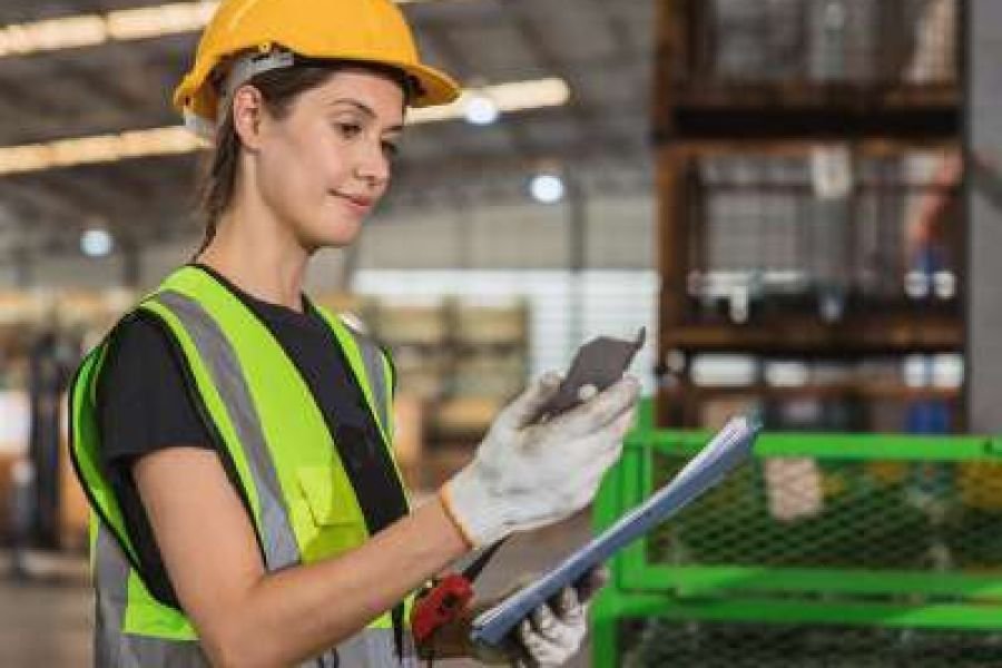 Aramco-certified QC inspector recording results on a project site