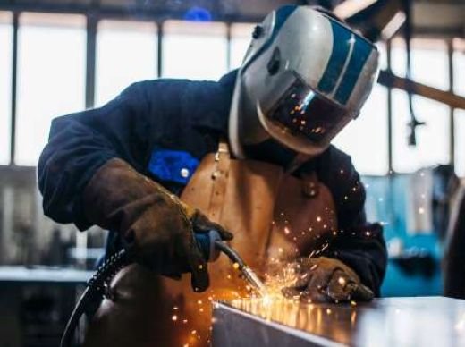 Certified welder at work in a fabrication workshop